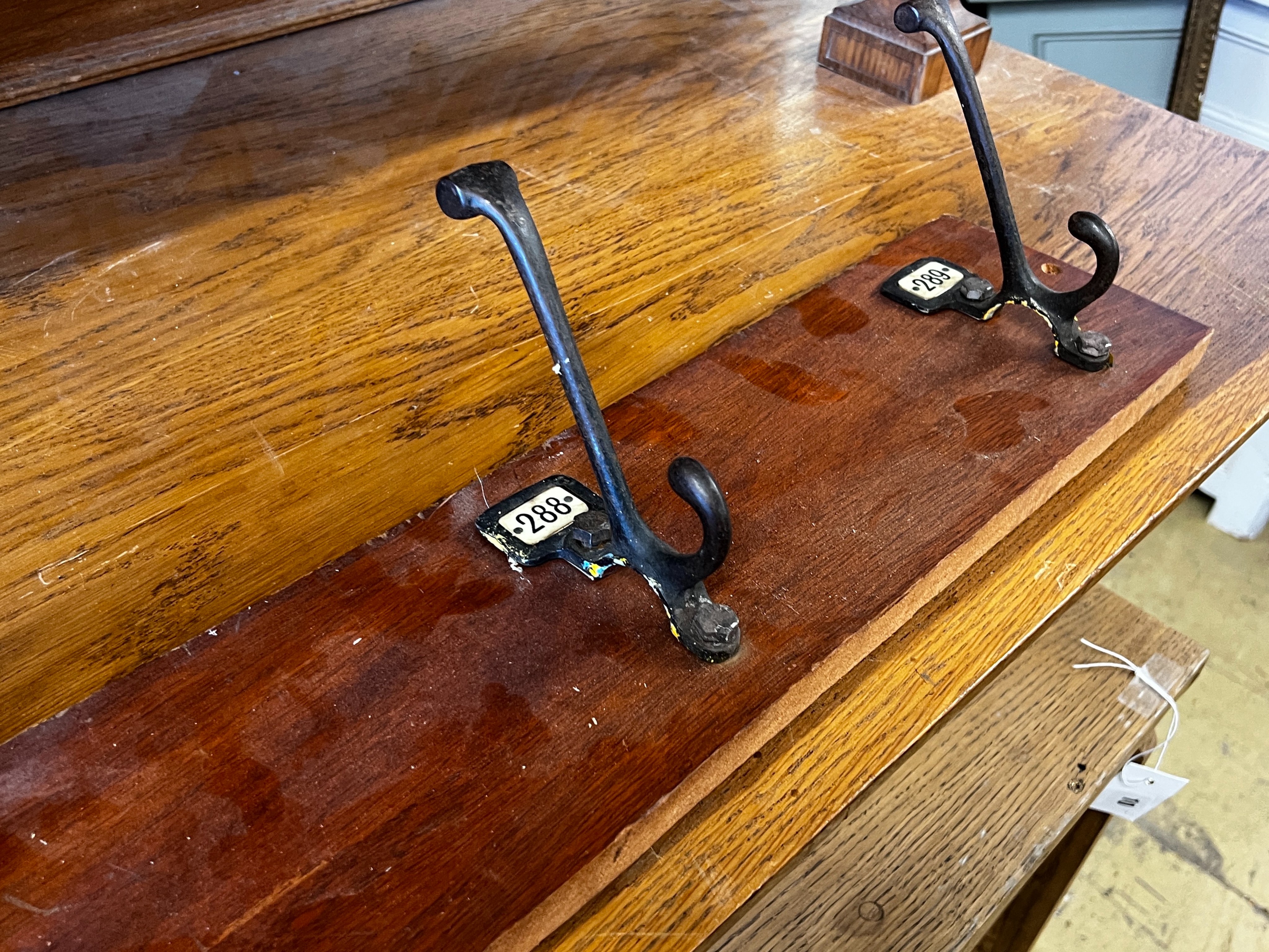 An oak pigeonhole unit, width 112cm, height 86cm together with a vintage four hook coat rack, width 86cm